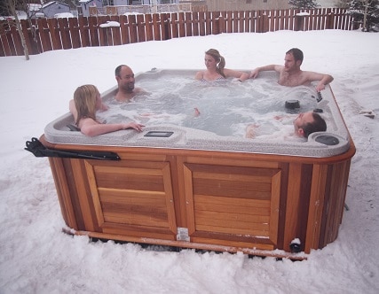 five person in an Arctic Spas hot-tub in winter